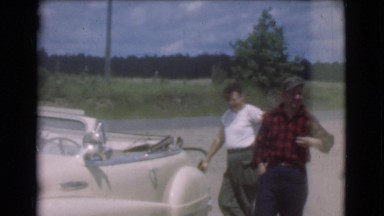 1951: gentlemen discussing the value of vehicles on a sunny afternoon CANADA