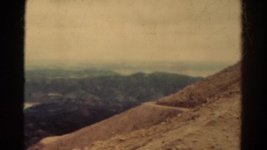 1967: man filming landscape from mountainside COLORADO
