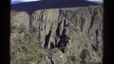 1967: view of grand rock face vista featuring hazy mountains in the distance