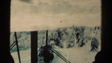 1967: conductor driving railroad double exposure of western dry landscape train