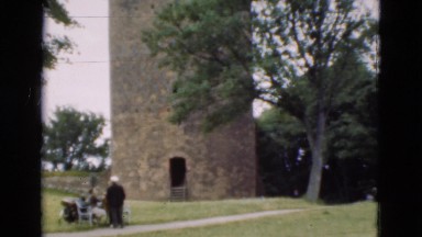 1948: castle tower building with european charm in open green field. DENMARK