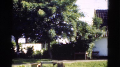 1948: person holds child outdoor of house DENMARK