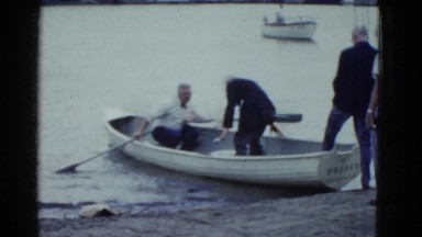 1951: Old Men Climbing Into Boat and Rowing on Lake Waters, Danville, Illinois