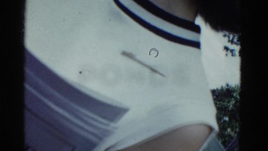 1951: partial shot of woman's chest, parked car, and boats on lake DANVILLE