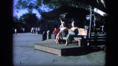 1963: lovely video of two women enjoying day outdoor, while sitting on bench.