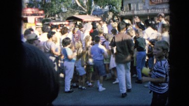 1963: crowd is seen posing beside car. CALIFORNIA