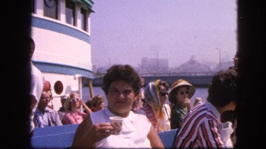 1963: chubby cute short haired girl drinking water on ferry cruise boat