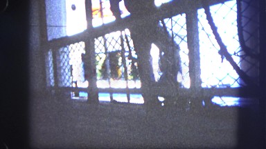 1963: boat coasting into harbor as seen through grate CALIFORNIA