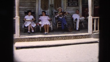 1963: man plays the fiddle on porch CALIFORNIA