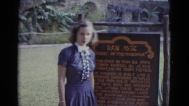 1952: girl posing by san jose mission information public park sign. NEVADA