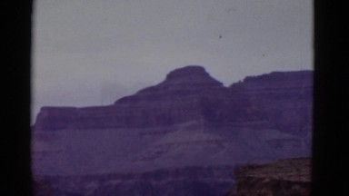 1952: panoramic view of huge canyon featuring small muddy river running through