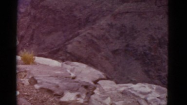 1952: people standing on the edge of large canyon, perhaps the grand canyon