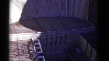 1952: large hydro electric dam face holding back water CALIFORNIA