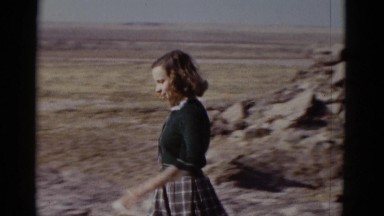 1952: young girl going down rocky trail visiting the site in the sun CALIFORNIA