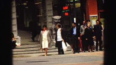 1968: a crowd on a city sidewalk waiting to cross the street VANCOUVER, CANADA