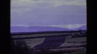 1969: a hilly green field with mountains in the background ENGLAND