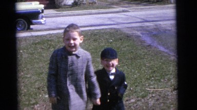 1963: two rambunctious well dressed boys standing on the lawn CAMDEN, NEW JERSEY