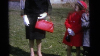 1963: an adult woman, accompanied by two little girls, is standing