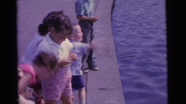 1963: children throwing bread to the pond to feed the ducks CAMDEN, NEW JERSEY