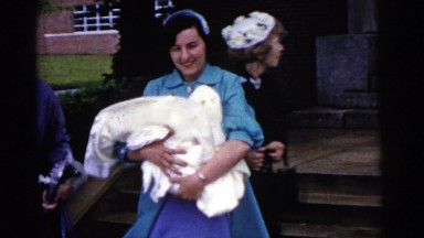 1961: Women Walking Down Steps with White Linen in Their Arms Detroit, Michigan