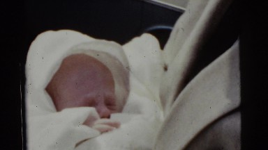 1961: Father Talking to Sleeping Baby Detroit, Michigan
