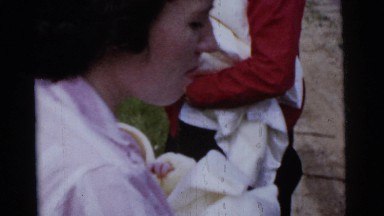 1961: Woman Holds Newborn Baby and Smokes Cigarette