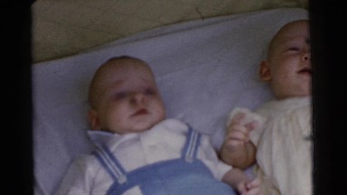 1961: two small infants in a crib