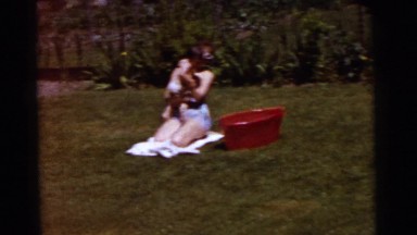 1961: an outdoor beach is seen with people diving in the water DETROIT, MICHIGAN