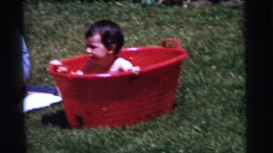 1961: a naked child is seen in a mini pool DETROIT, MICHIGAN