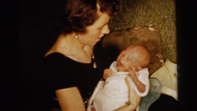 1961: happy mother with her newborn baby infant DETROIT, MICHIGAN