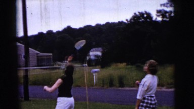 1961: the family playing badminton with dog and small child