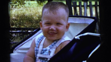 1961: baby boy smiles grins cute in outdoor park DETROIT, MICHIGAN