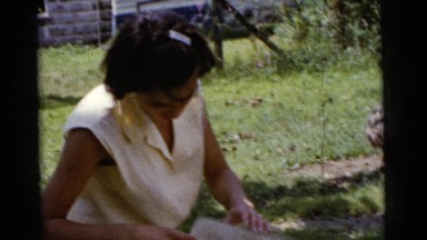 1961: women outside in the yard with a baby in a stroller DETROIT, MICHIGAN