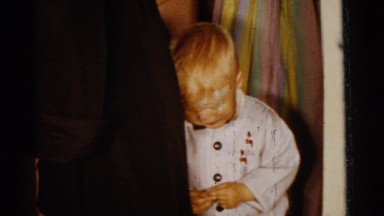 1961: a toddler being introduced to two young babies by several women DETROIT