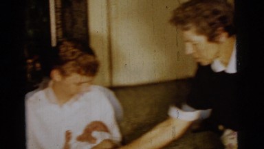 1961: parents taking care of twin babies at same time while they cry DETROIT