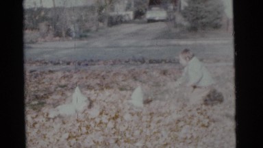 1963: kids having fun raking leaves and jumping into the pile CAMDEN, NEW JERSEY