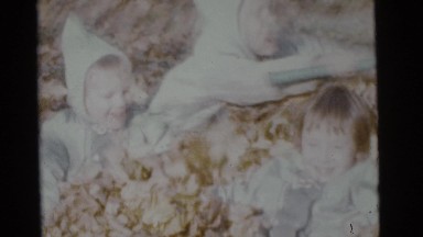 1963: young children playing in the leaves. CAMDEN, NEW JERSEY