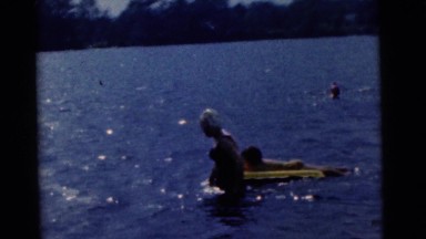 1963: two mothers with children learning to swim CAMDEN, NEW JERSEY