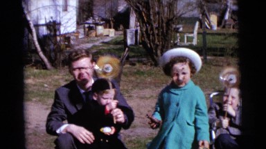 1963: family outside at easter with baskets playing with pinwheels CAMDEN