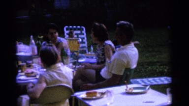 1963: family member talking to another at garden area. CAMDEN, NEW JERSEY