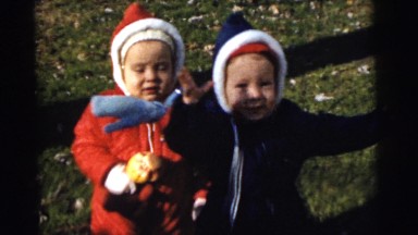 1961: two children dressed warm playing outside in the yard in the fall DETROIT