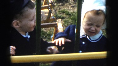 1961: two toddlers playing by a swing set on a beautiful afternoon DETROIT