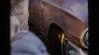 1968: man cleaning a car with wiper COTTONWOOD, ARIZONA