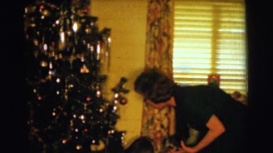 1961: a christmas tree is seen with a child opening presents CLARKSDALE, ARIZONA