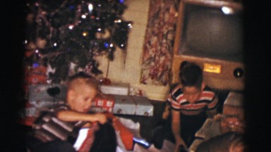 1961: children opening up presents and showing them proudly CLARKSDALE, ARIZONA