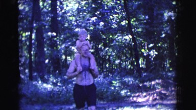 1961: a man carrying a boy on his shoulders CLARKSDALE, ARIZONA