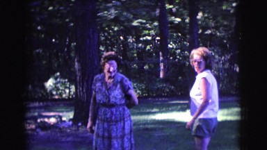 1961: three women and a dog gathering outside in a wooded area CLARKSDALE