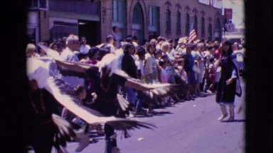 1961: looking at some people performing a traditional dance on a festival