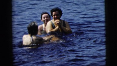 1962: a family takes a refreshingly cold dip in a pond on a sunny day. CAMDEN