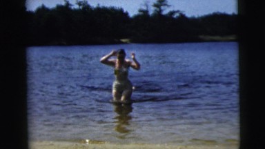 1962: white woman getting out of the water after a swim CAMDEN, NEW JERSEY